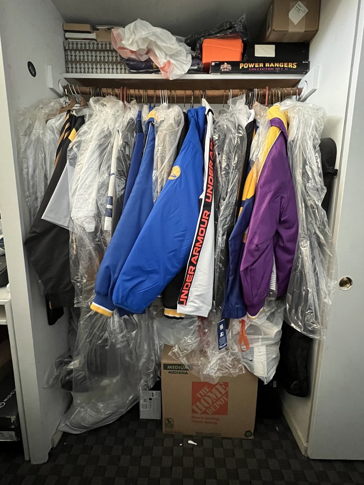 Disorganized closet with random household items, sports gear, and miscellaneous objects scattered throughout