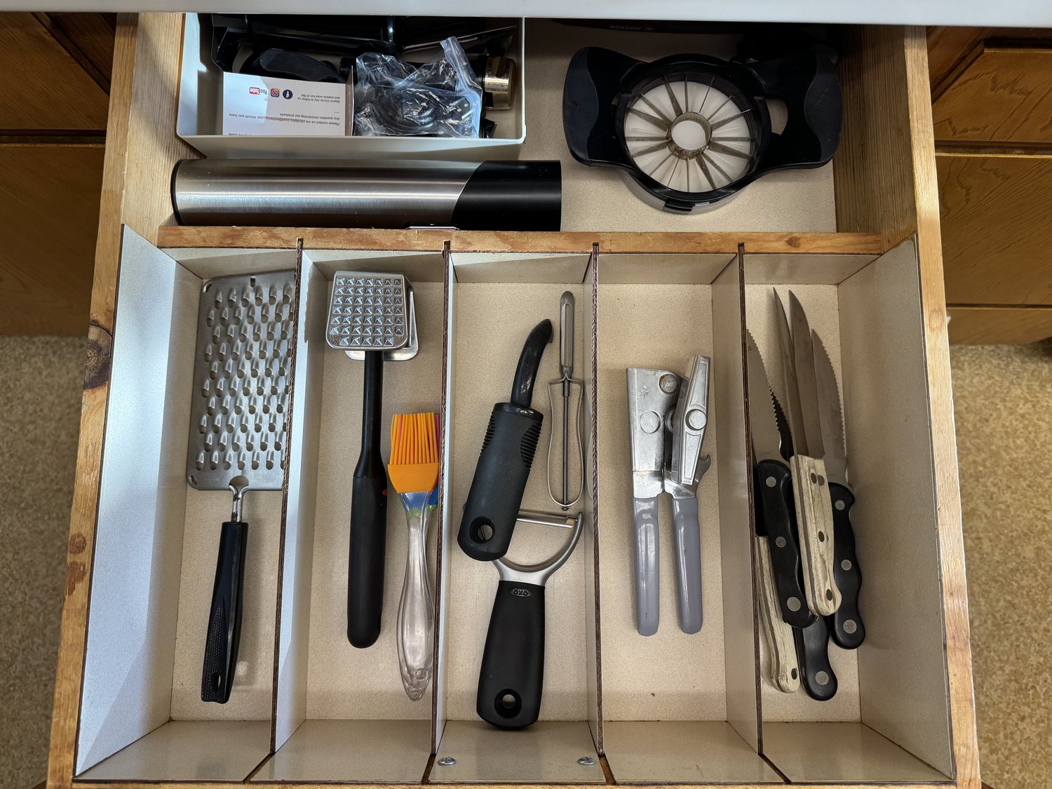 Organized kitchen drawer with utensils sorted in compartments, each tool easily accessible and visible