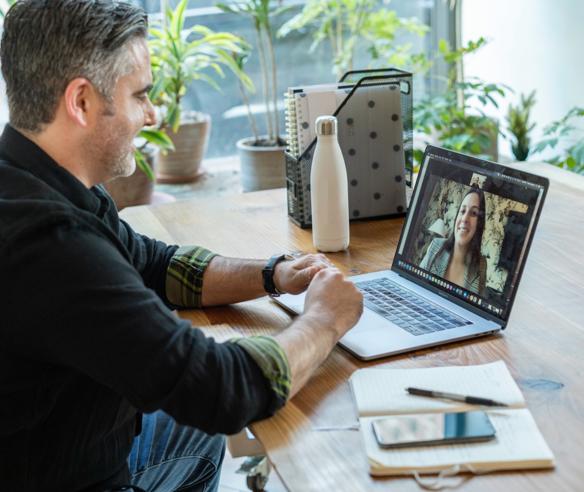 Professional organizer conducting virtual consultation via video call, providing remote organizing guidance and support